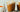 Two glass mugs of Pumpkin Maple Hot Cocoa with whipped cream and spices on top