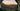 Picture of sunset over the mountains through the door of a tent with a stainless steel mug