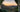 Picture of sunset over the mountains through the door of a tent with a stainless steel mug