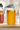 A glass mason jar pitcher of Full Moon Tea cold-brewed tea with a pour lid on a kitchen counter with another pitcher of summer tea next to it.