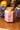 Jar of lavender lemon creamed honey from The Ramlin Bee on a wooden surface with blurred background