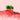 A strawberry in pink liquid with a pink background.
