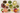 colorful tea beverages in large glass mugs with dried herbs and slices of citrus