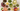 colorful tea beverages in large glass mugs with dried herbs and slices of citrus