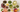 colorful tea beverages in large glass mugs with dried herbs and slices of citrus
