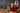 A frosted glass of Cranberry Sparkling Sangria with holiday decor and berries around it.