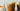 Two glass mugs of Pumpkin Maple Hot Cocoa with whipped cream and spices on top