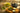 loose leaf green tea in bowls on wooden table with cast iron tea pot
