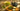 loose leaf green tea in bowls on wooden table with cast iron tea pot