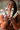 Woman holding four boxes of artisan honey sticks for loose leaf tea with a blurred background