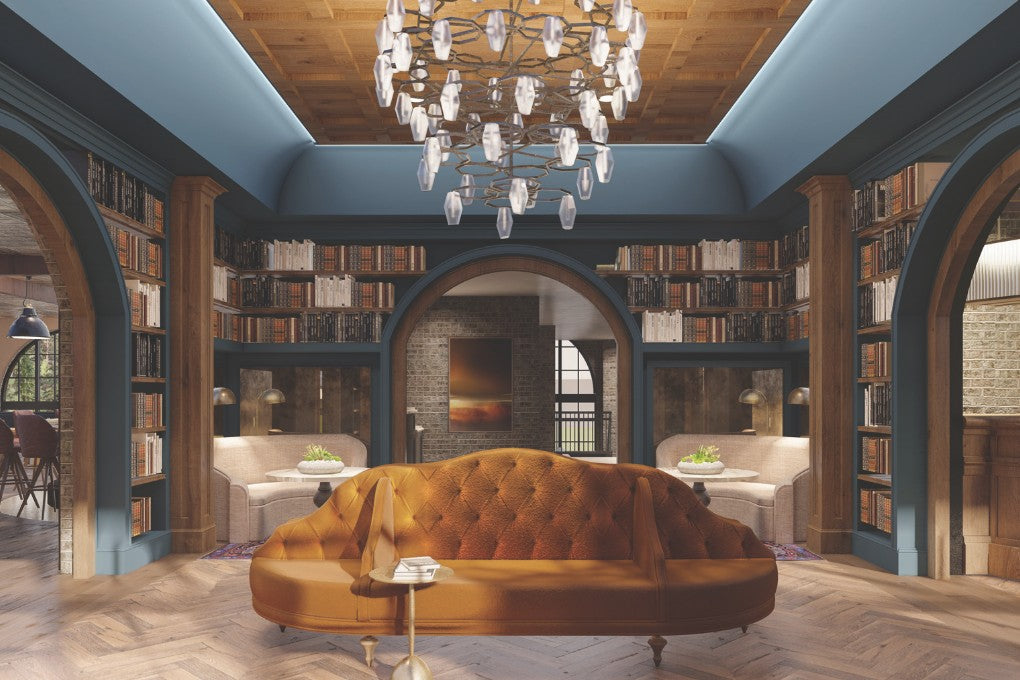 A grand library with curved arches and a gold couch in a boutique hotel in Asheville, NC